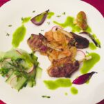 Mini cotlete de miel servit cu ceapa caramelizata, chips de cartofi, sos de patrunjel si salata